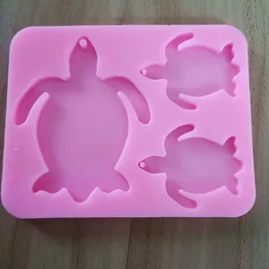 Close-up detail showing the smooth surface of the pink silicone turtle mold with 3 cavities for DIY.