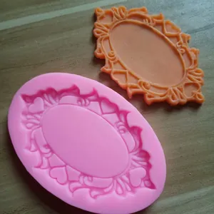 Macro view of a pink silicone mold showing detailed vintage heart frame pattern for fondant