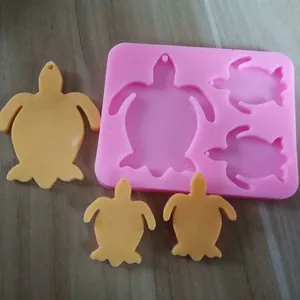 Detail view of 3-cavity sea turtle silicone mold with finished resin turtle casts