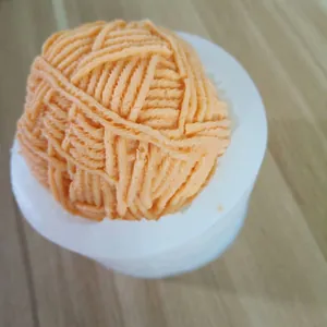 Close-up of 3D yarn ball silicone mold with textured orange cast model