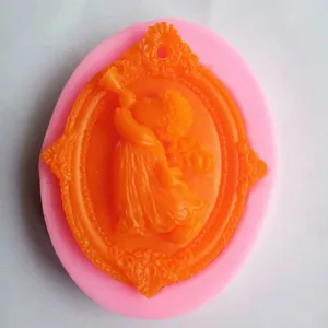 Detailed macro view showing an angel blowing trumpet silicone mold with orange craft finish