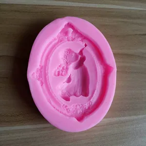 Detailed view of pink silicone mold featuring a cherub angel with a trumpet design