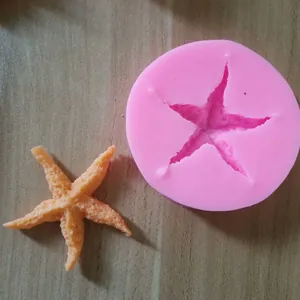 High-quality detailed view of pink starfish silicone mold and finished fondant shape