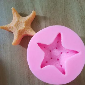 Detail view of pink starfish silicone mold and textured fondant starfish