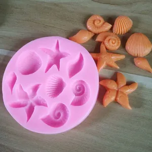 Detailed macro view of pink silicone mold featuring ocean shells and starfish shapes