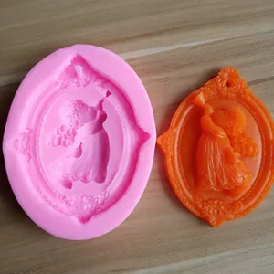 Detailed macro view of a pink silicone angel mold with its orange wax sample casting