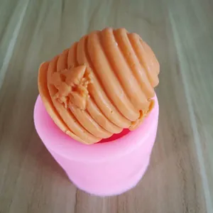 Detailed view of a 3D beehive silicone mold with a molded beeswax bee candle