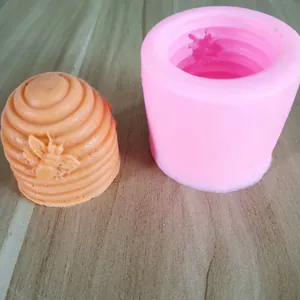 Close-up of 3D beehive silicone mold and orange honeycomb finished product detail.