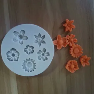 Vista dettagliata dello stampo in silicone bianco con decorazioni in fondant arancio