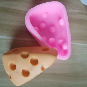 Detail of a triangular cheese-shaped silicone mold for DIY baking and chocolate cake decorating.