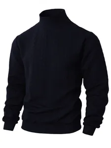 Close-up of navy blue men's cable knit turtleneck sweater with warm textured pattern.