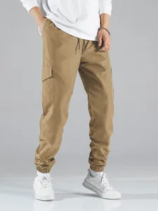 Men's khaki multi-pocket cargo joggers featuring elastic cuffs and drawstring waist.