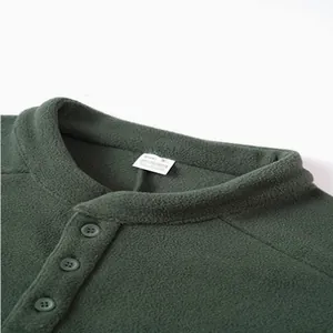 Detailed view of dark green men's fleece sweatshirt collar and 3-button design