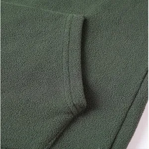 Macro detail of the olive green fleece fabric and neat stitching on a men's sweatshirt