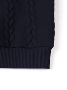 Macro detail of navy blue men's cable knit sweater showing ribbed hem and texture