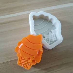 Detailed view of a soft-serve ice cream cone silicone mold with orange resin sample product