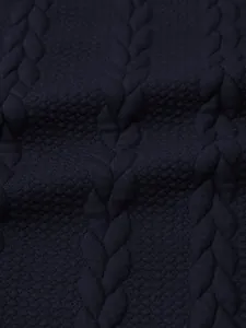 Detailed macro view of dark navy cable knit fabric texture for men's winter sweater