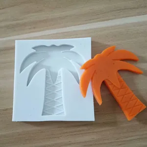 Silicone baking mold in coconut tree shape shown with an orange finished decoration piece