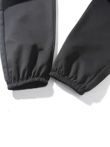 Detail view showing elasticized leg cuffs of black cotton jogging sweatpants for men