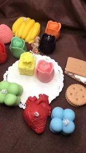 Macro view of various colorful 3D handmade scented candles in rose and heart shapes