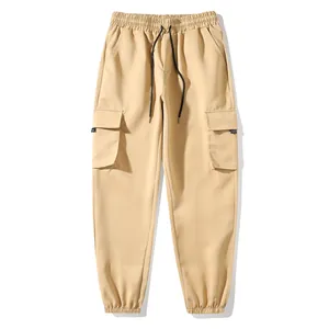 Close-up view of khaki cargo jogger pants featuring an elastic drawstring waist and side pockets