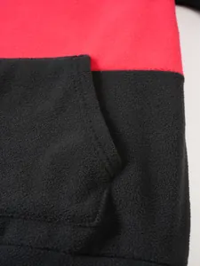 Close-up detail of the soft fleece fabric and pocket stitching on red and black hoodie