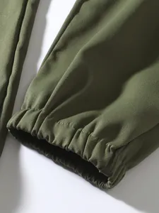 Close-up of elasticated cuffs on olive green men's vintage cargo joggers