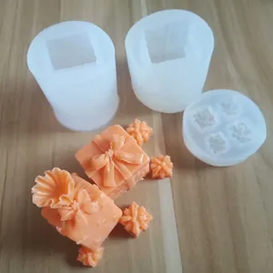 Close-up of 3D gift box silicone molds with finished orange fondant cake decorations
