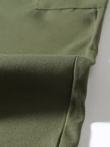 Macro detail of olive green twill fabric and pocket stitching on men's cargo pants