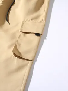Detailed macro shot of khaki cargo pants side pocket and fabric texture with black drawstring