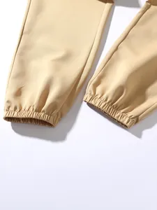 Detailed close-up showing the elasticated leg cuffs of khaki cotton jogger cargo pants