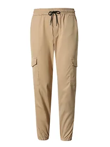 Detail view showing front of khaki cargo pants with elastic drawstring waist and pockets