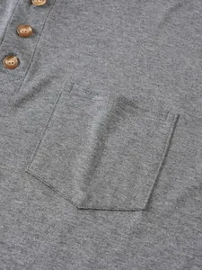 Primer plano del bolsillo del pecho y botones de un polo gris casual para hombre