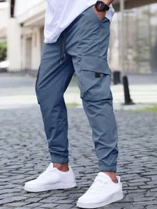 Men's blue cargo joggers with drawstring waist and elastic cuffs in outdoor setting