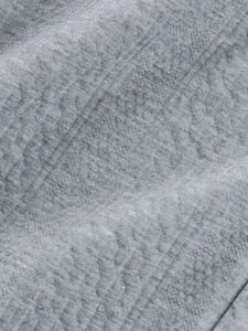 Detailed close-up showing the premium grey jacquard fabric texture of a men's sweatshirt