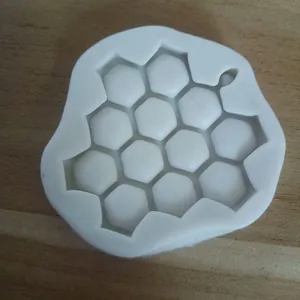 Close-up detail of a white silicone honeycomb mold for cake decorating and soap making