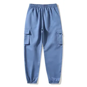 Detailed view of blue cargo jogger pants featuring an elastic waistband and side pockets
