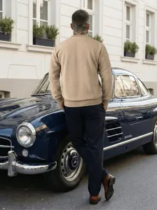 Back view of men's beige long-sleeve jacquard sweatshirt in outdoor street setting