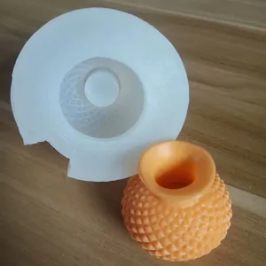 Detailed macro shot of the 3D vase silicone mold alongside a textured orange product.