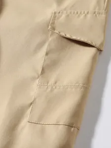 Close-up macro view showing the durable flap pocket and stitching on khaki cargo pants.