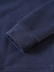 Detailed close-up showing the soft fleece fabric and ribbed cuff of the navy blue hoodie