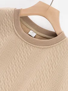 Close-up of beige men's sweatshirt showing intricate jacquard texture and ribbed collar