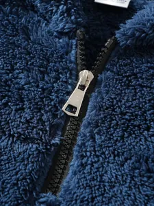 Macro detail of high-quality zipper on navy blue plush men's fleece jacket