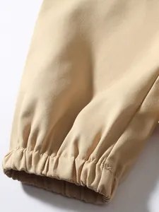 Detailed macro shot of the elastic cuff and twill fabric texture on khaki cargo pants