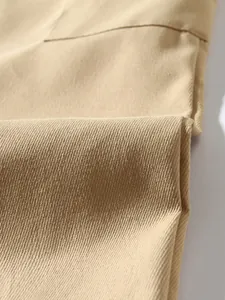 Close-up of durable khaki cotton twill fabric showing detailed texture of cargo pants