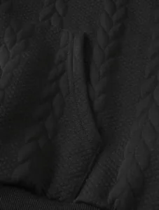 Close-up of black cable-knit jacquard fabric texture on a men's casual hoodie