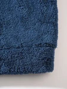 Close-up detail of navy blue plush fleece fabric texture on men's winter jacket