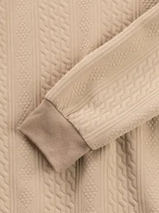 Close-up of khaki jacquard fabric texture and ribbed cuff on men's sweatshirt