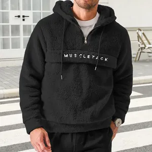 Men's black sherpa fleece half-zip hoodie featuring white MUSCLETACK letter print detail
