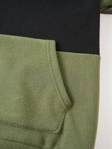 Close-up showing the soft fleece texture and kangaroo pocket of a color-block hoodie.